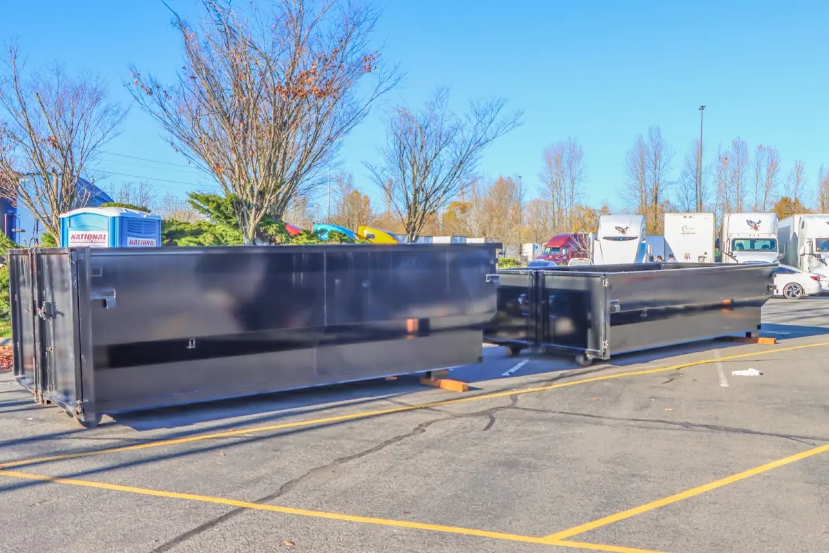 Professional dumpster rental service with roll-off container on residential driveway in Gallatin